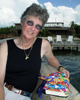 Barb Blanton with book cover and wallet